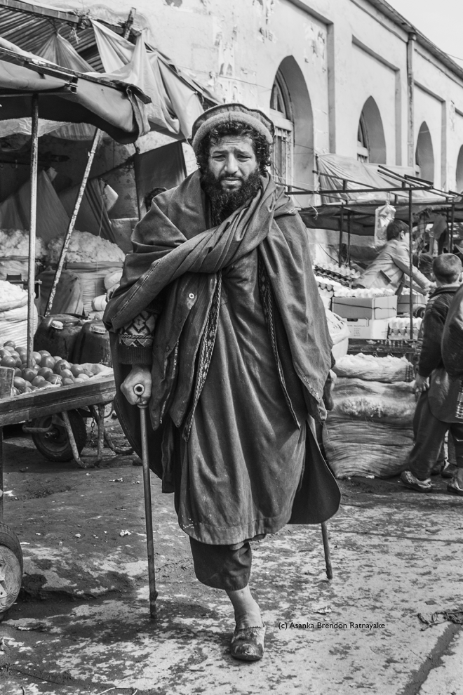 A former Mujahideen Soldier poses for a portrait at a Bazaar in Bagram.